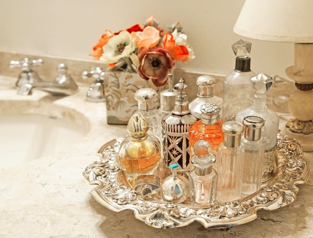 Various perfumes are on the tray in the bathroom
